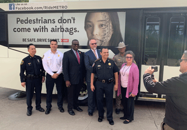 Partner in front of Metro bus during press conference
